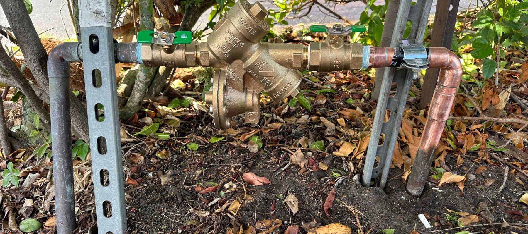 Outdoor backflow preventer assembly with copper piping and brass fittings
