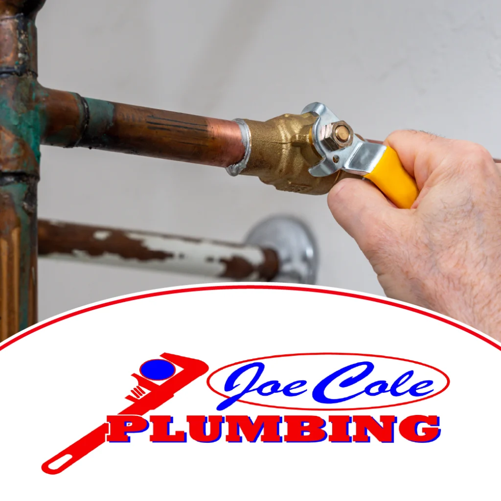 A hand using a wrench to adjust a valve on a copper pipe, with the Joe Cole Plumbing logo at the bottom