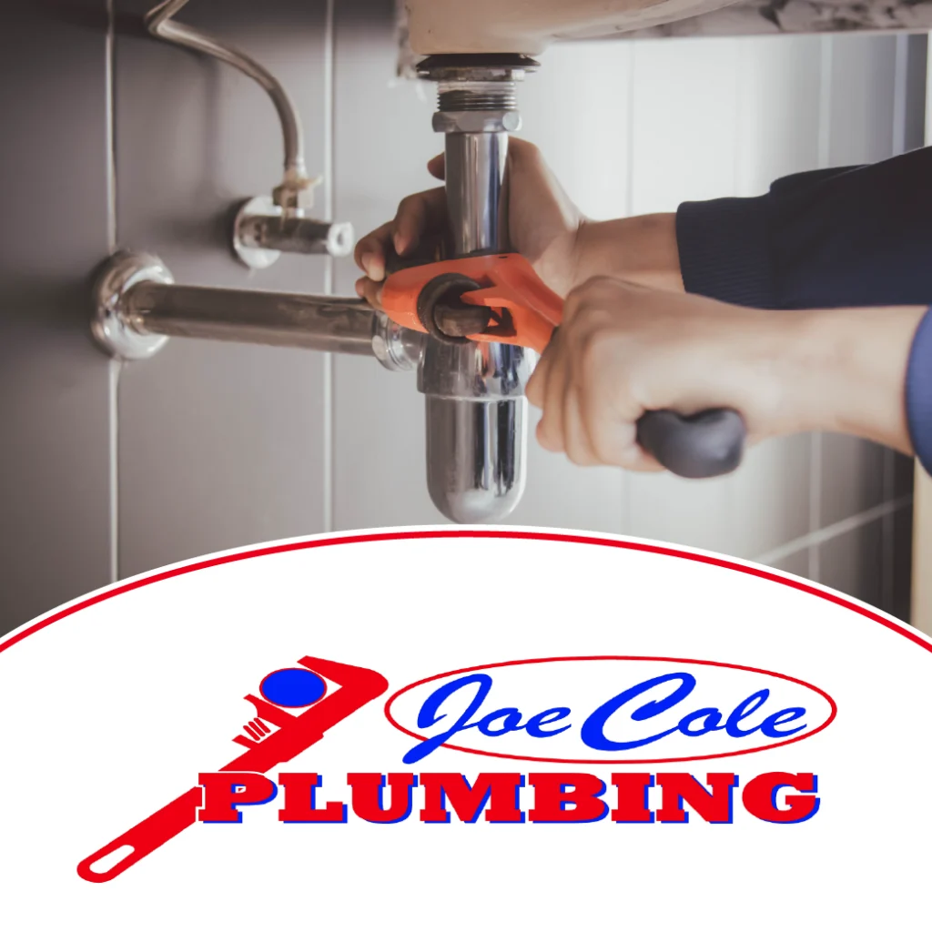 Joe Cole Plumbing logo overlaid on a plumber repairing a sink pipe with a wrench