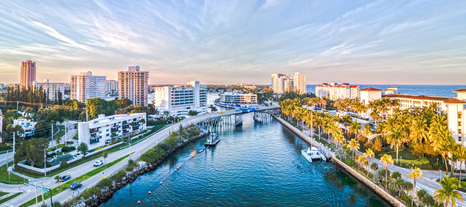 Waterfront cityscape of Boca Raton, Florida, with a bridge and high-rise buildings near the coast