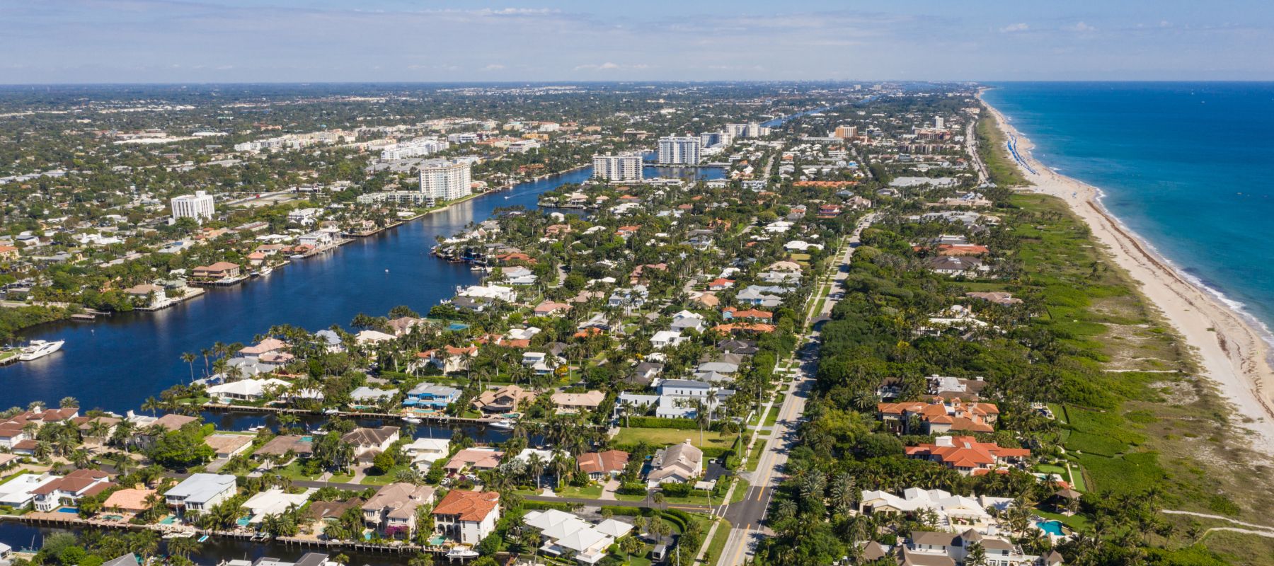 Aerial view of a Florida suburb with lakes and red-roofed homes