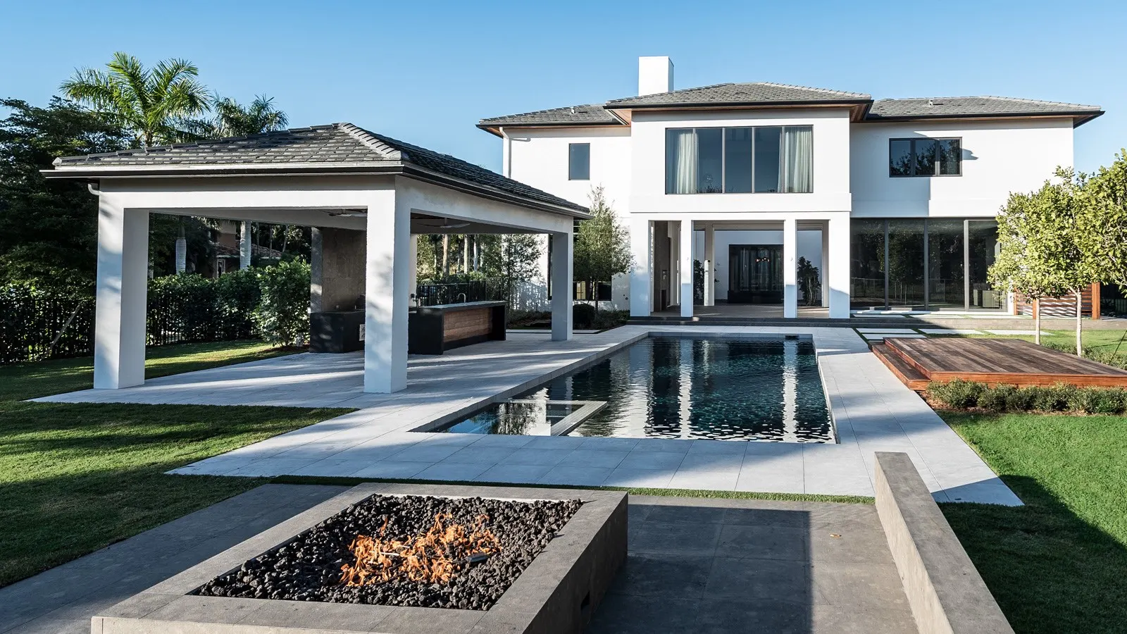 Modern waterfront home with pool and outdoor living area in Miami Beach