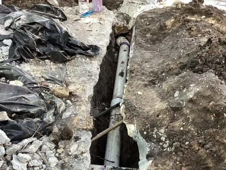 Residential sewer line repair with exposed underground plumbing pipe