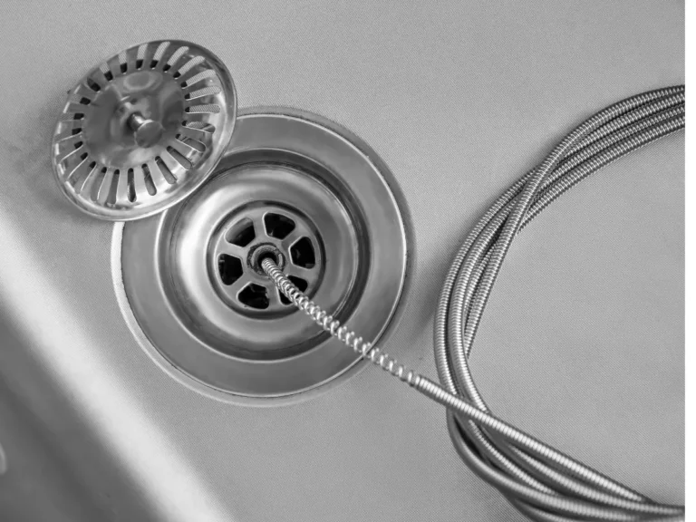 Kitchen drain cleaning service removing a clogged sink drain